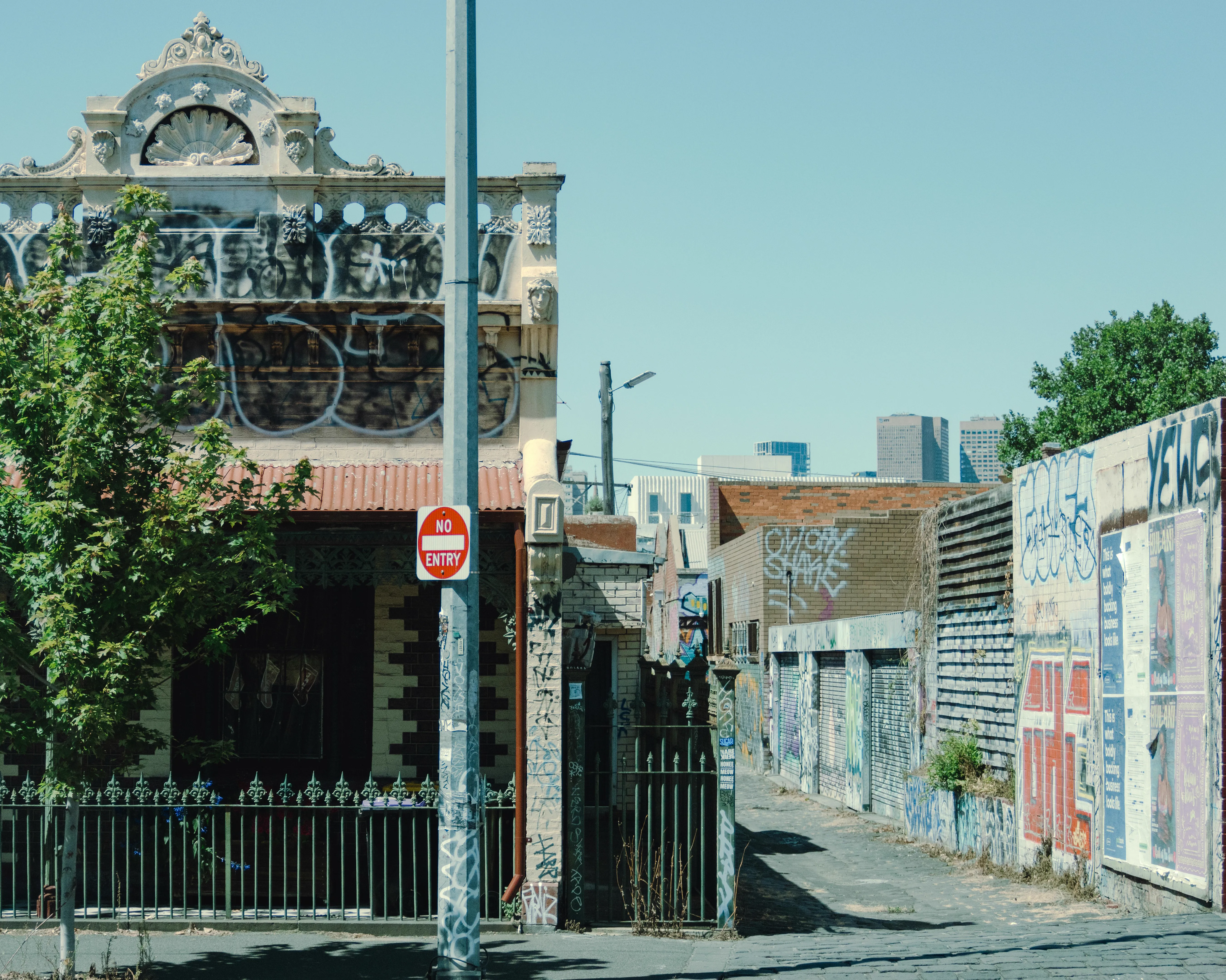 Victorian rental property with Melbourne cityscape, representing VIC landlord tenancy law and regulations